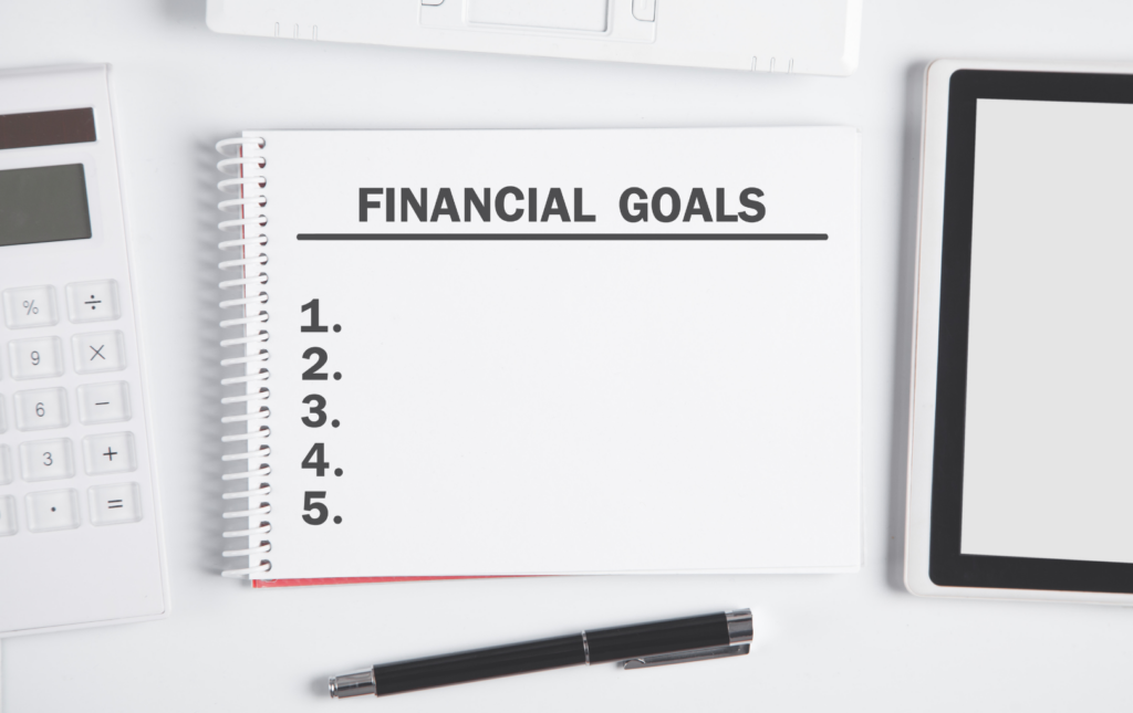 A Pad With A Numbered List Of Five Financial Goals That Have Not Been Filled In Yet