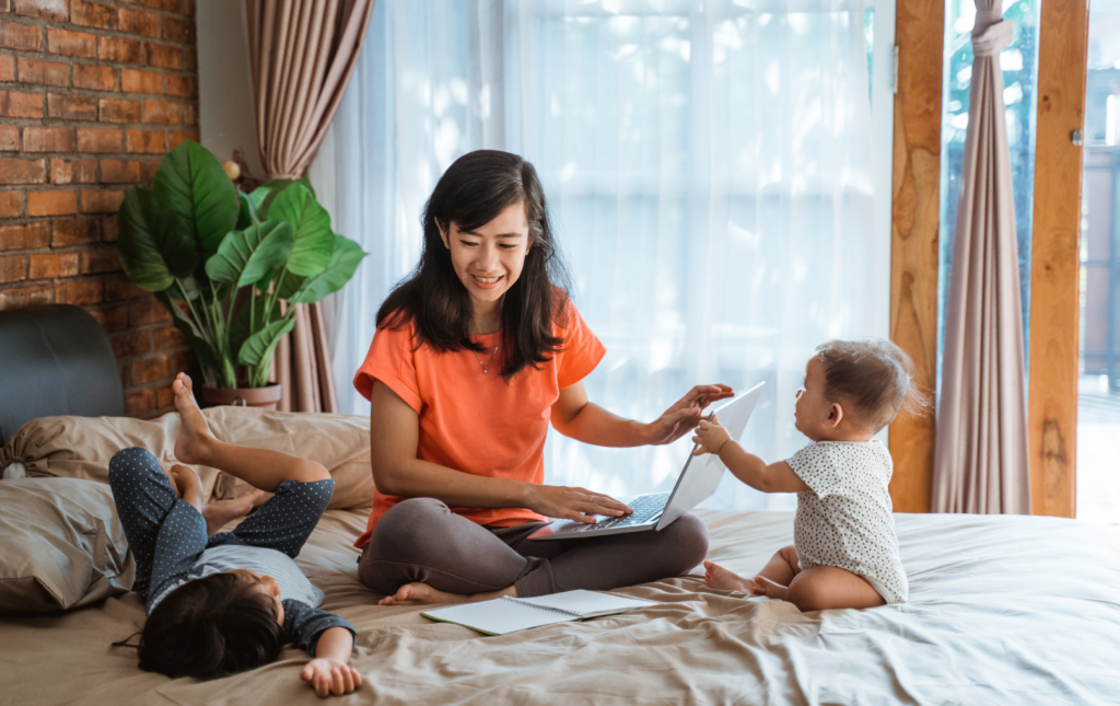 Woman caring for her two small children and also empowering herself with her finances