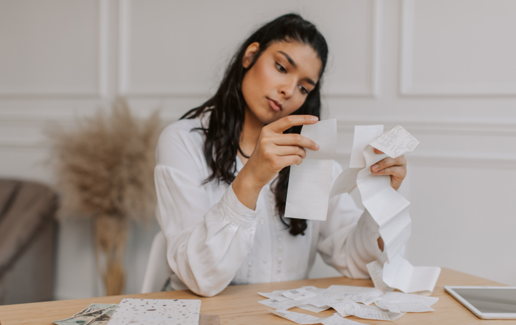 A Woman Looking At Receipts For Health Savings Account Expenses