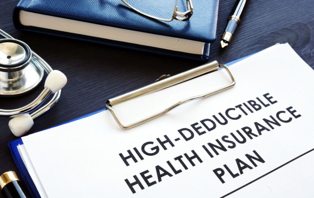 High-Deductible Health Insurance Plan visible in a clipboard 