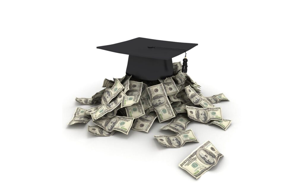 A graduation cap atop a pile of paper currency to be representative of college education. get the most from it.